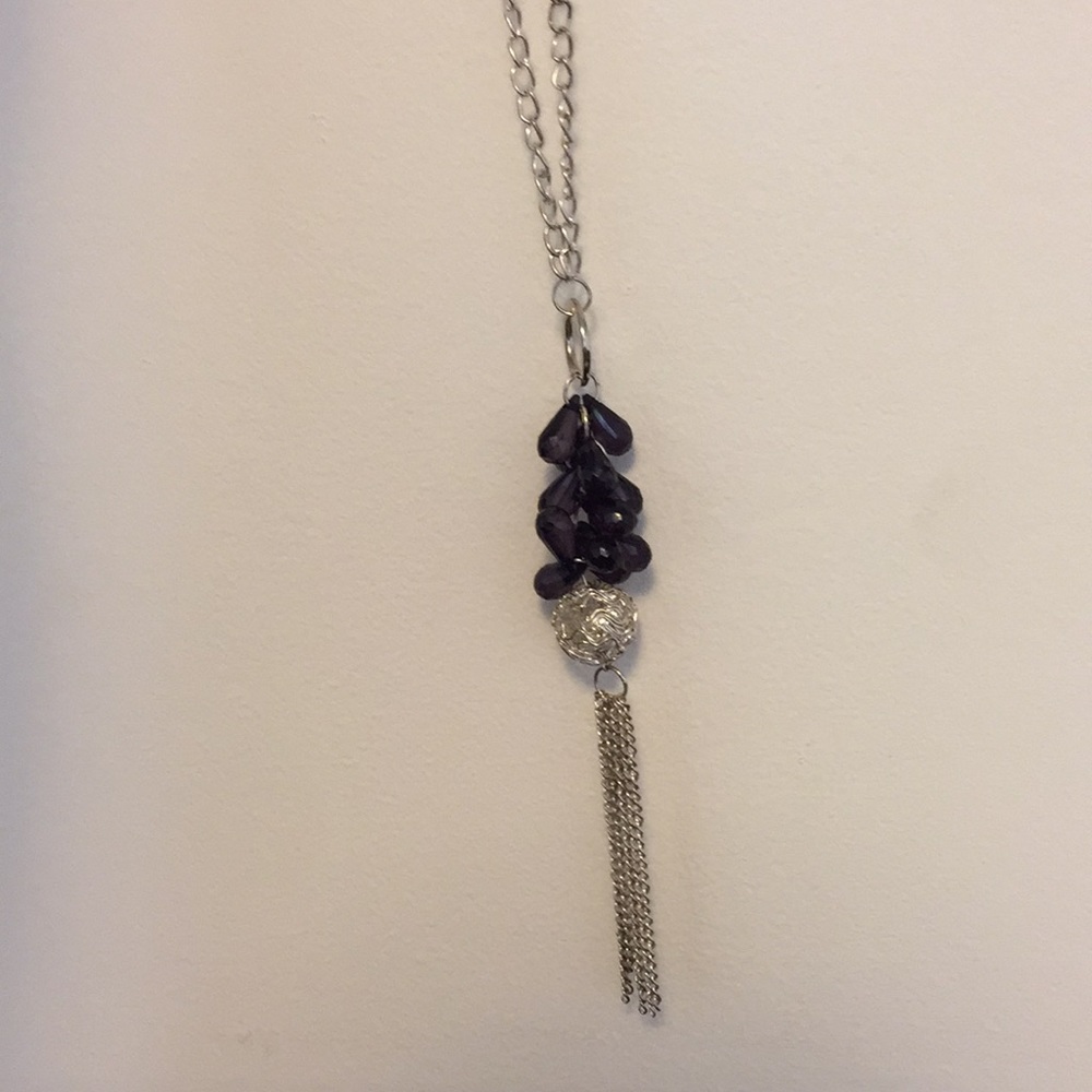 Long silver necklace with black beads and tassel